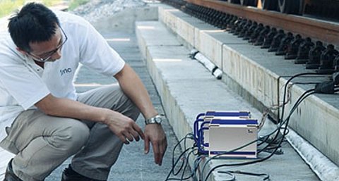 Engineer conducting railway brake test and inspection using imc measurement system on rail vehicle